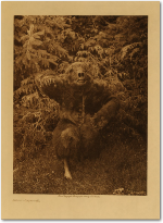 Dancer dressed in a full-body bear-skin with a carved mask and claw gauntlets